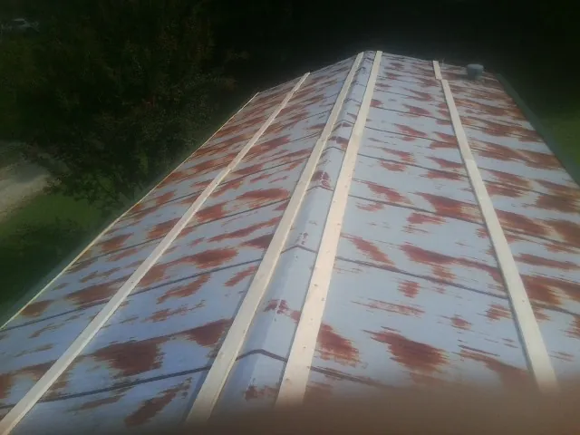 Rusted metal roof panels with new wood purlins before replacement — Storm Damage Roof Repair in Allentown by Roofing Brothers