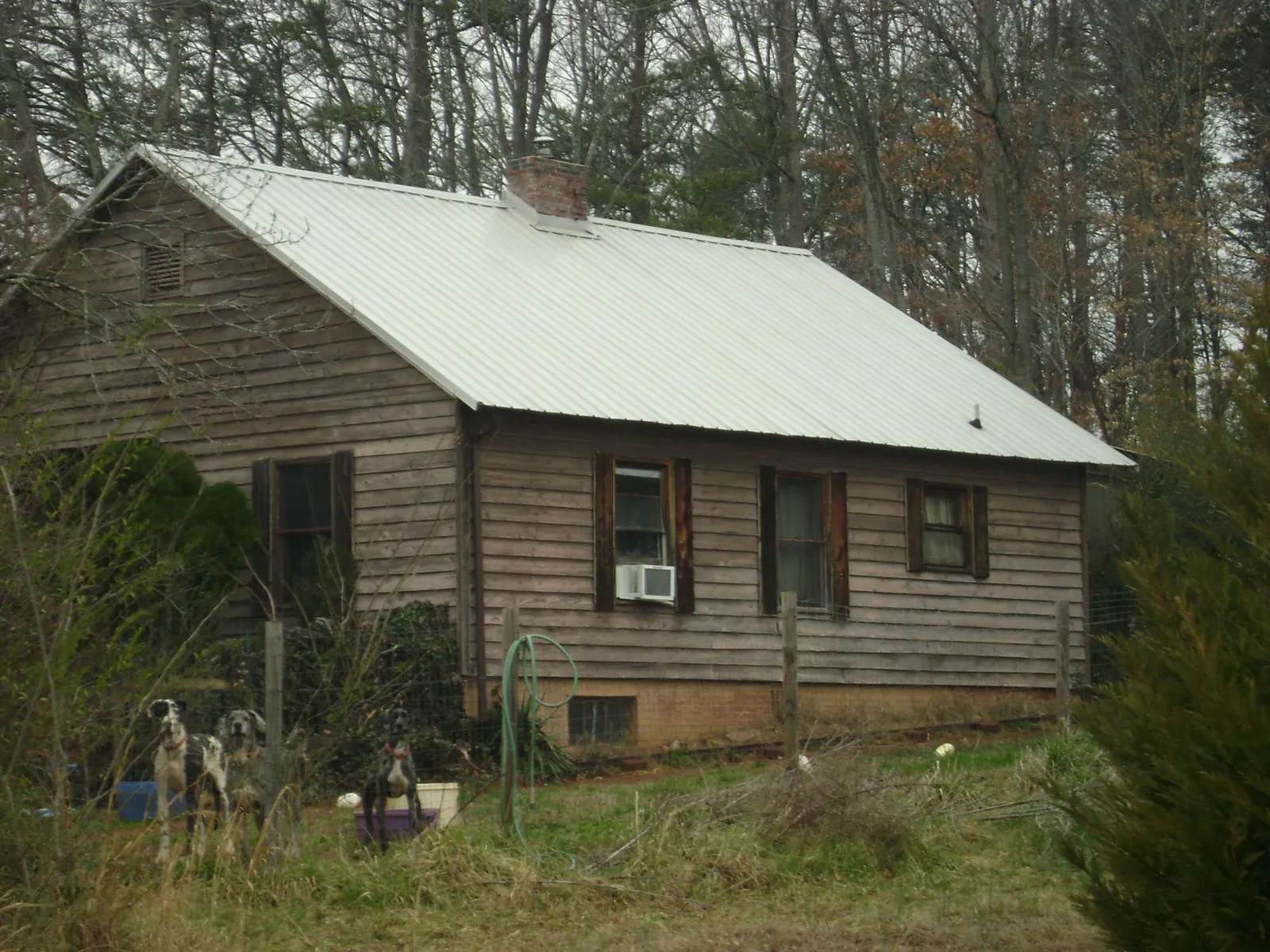 White metal roof on an old wood sided farmhouse, from a Metal Roof Installation job in Allentown